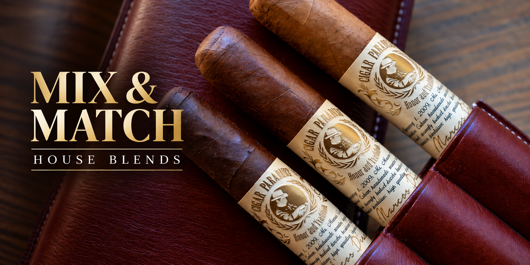Close-up of three Cigar Paradise Honor & Tradition cigars with gold and cream bands, displayed in an elegant burgundy leather cigar case.