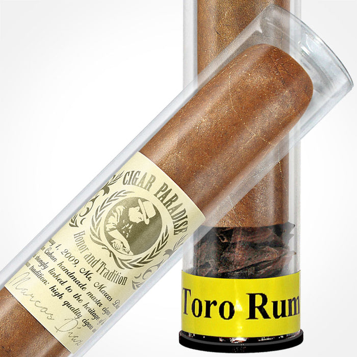Cigar Paradise Sabores Toro Rum 54x6 close-up inside a clear cigar tube, showing the tobacco wrapper, cigar band and yellow Toro Rum label.